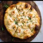 Shrimp pizza with golden crust and basil